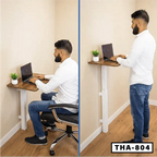 Adjustable wall-mounted laptop table used for sitting and standing, small potted plant on desk.
