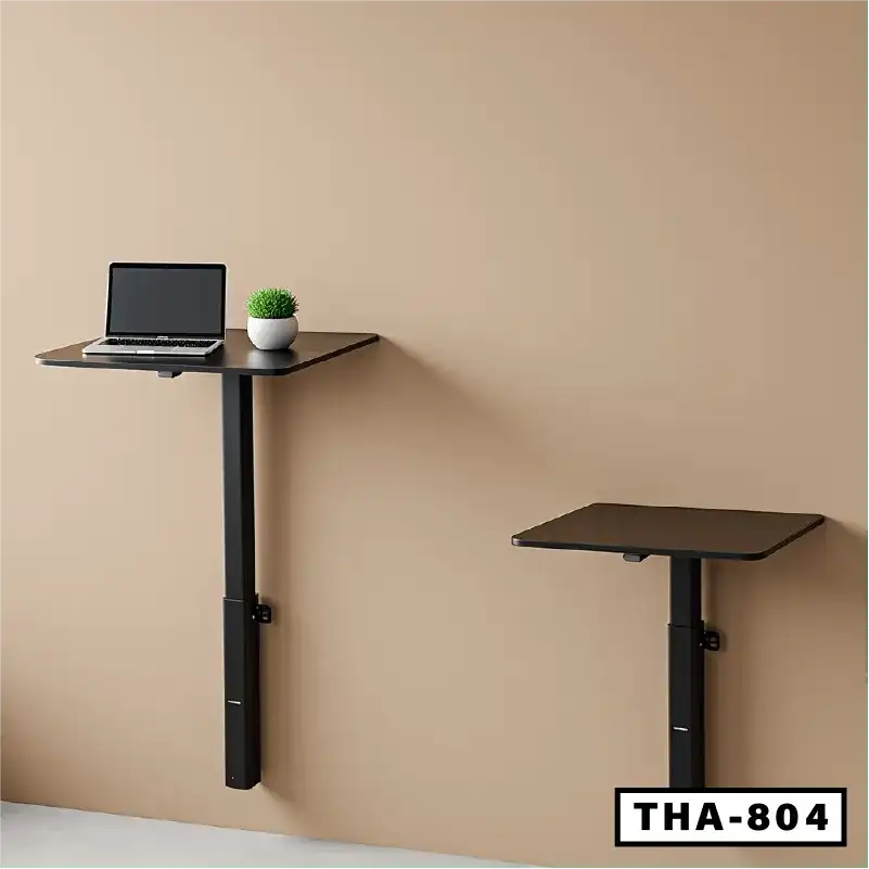 Adjustable wall-mounted laptop tables with black surface in modern office setting