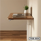Wall-mounted standing laptop table with wood finish, laptop, notebook, and plant