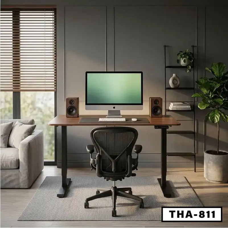 Modern standing desk with computer, speakers, and ergonomic chair in stylish home office setup.