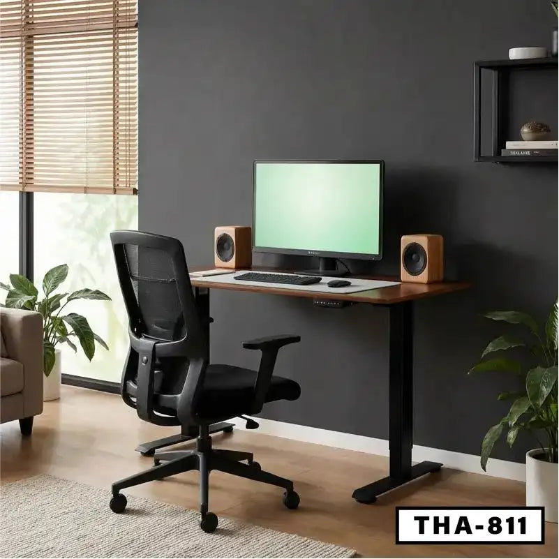Ergonomic office chair and modern standing desk with monitor in home office setup