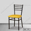 Modern steel dining chair with black frame and yellow cushion in minimalist room