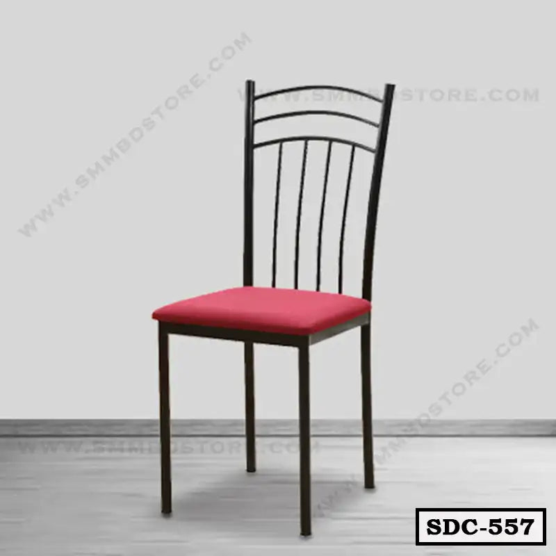 Steel dining chair with black frame and red cushioned seat on wooden floor