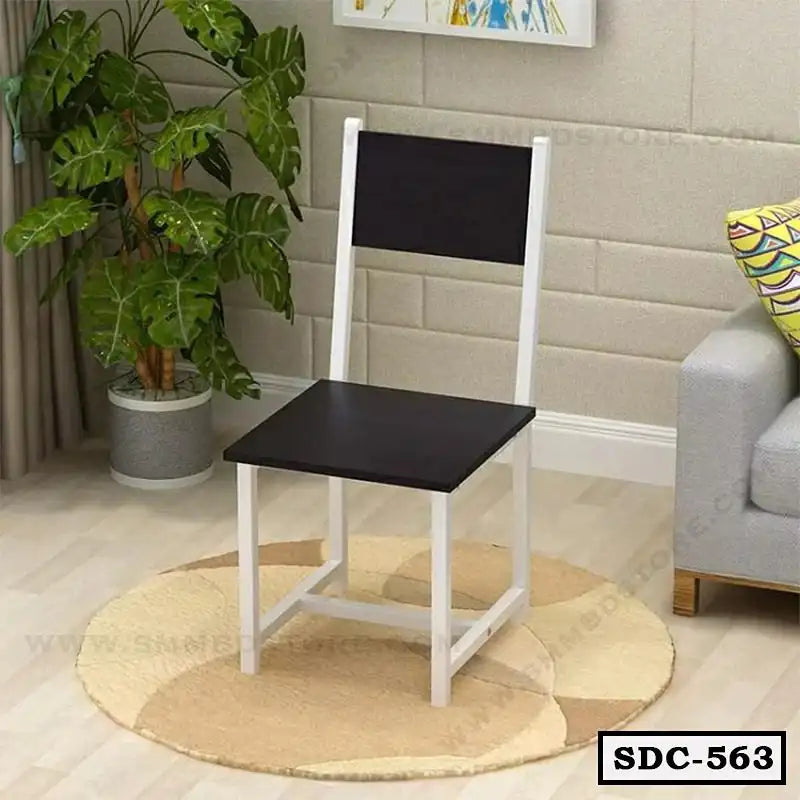 Modern steel dining chair with black seat and backrest, white frame, in a stylish living room.