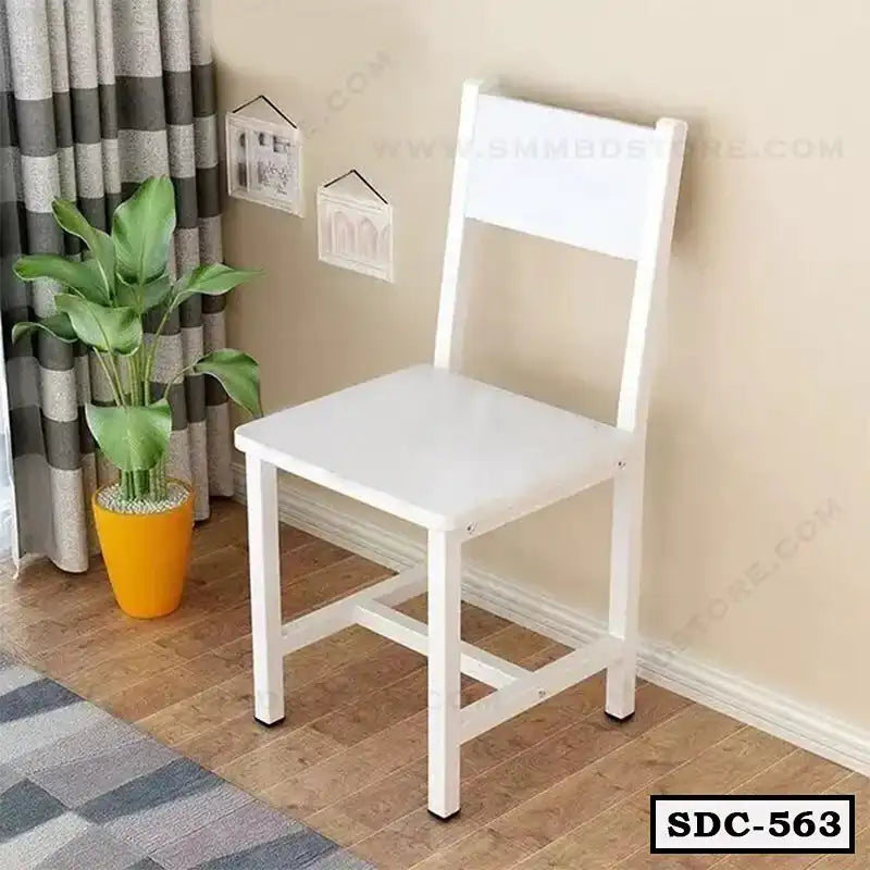White steel dining chair with square seat in a modern home corner, wooden floor, houseplant nearby.