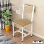 Modern steel dining chair with wooden seat and backrest in a bright room with a plant