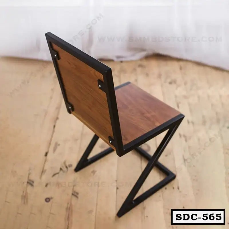 Modern steel-frame dining chair with wooden seat and back on a wooden floor