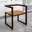 Modern steel dining chair with wooden seat, minimalist design, ideal for home or office.