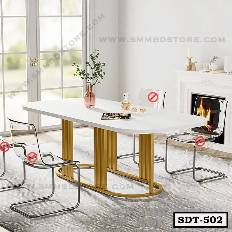 Modern steel dining table with gold base and white top in a bright dining room with transparent chairs