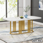 Modern white steel dining table with gold legs in a stylish room, minimalist decor