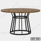 Round steel dining table with wooden top and modern black metal base, minimalist design