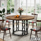 Round steel dining table with wooden top, four chairs, and floral centerpiece in modern dining room