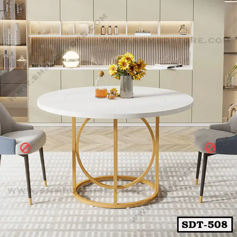 Modern round steel dining table with white top and gold base, set in a stylish dining room