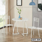 Modern white steel dining table set with two chairs in a bright home interior