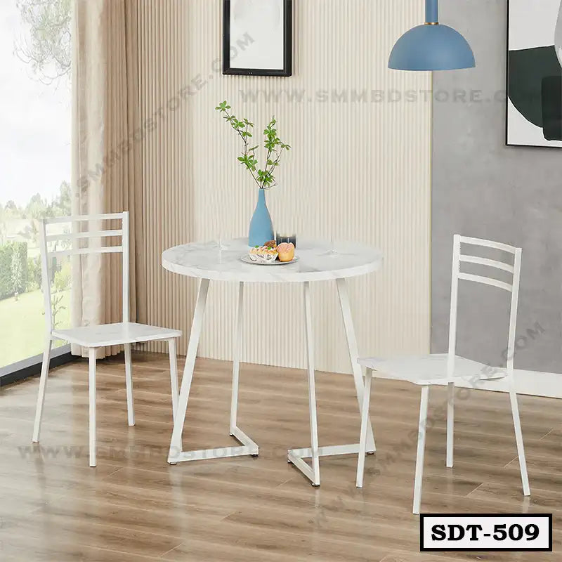 Modern white steel dining table set with two chairs in a bright home interior