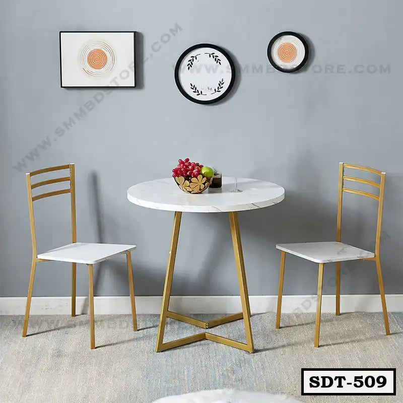Modern steel dining table set with two white chairs and gold frames in a minimalist room