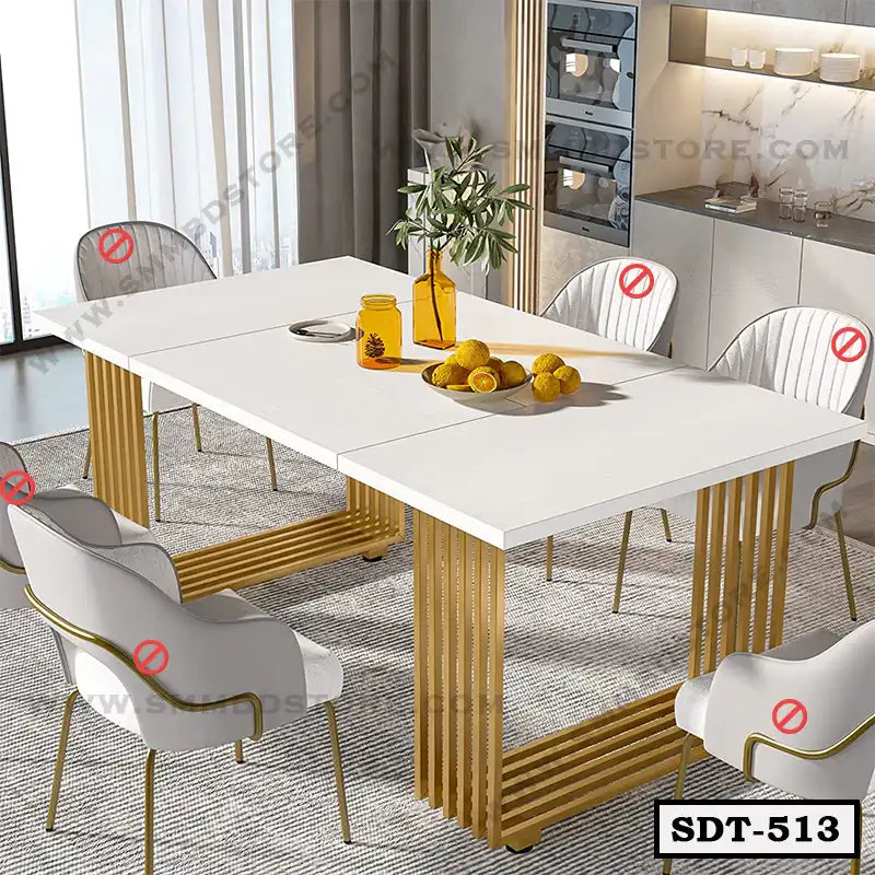 Modern steel dining table with white top, gold legs, six chairs in contemporary dining room