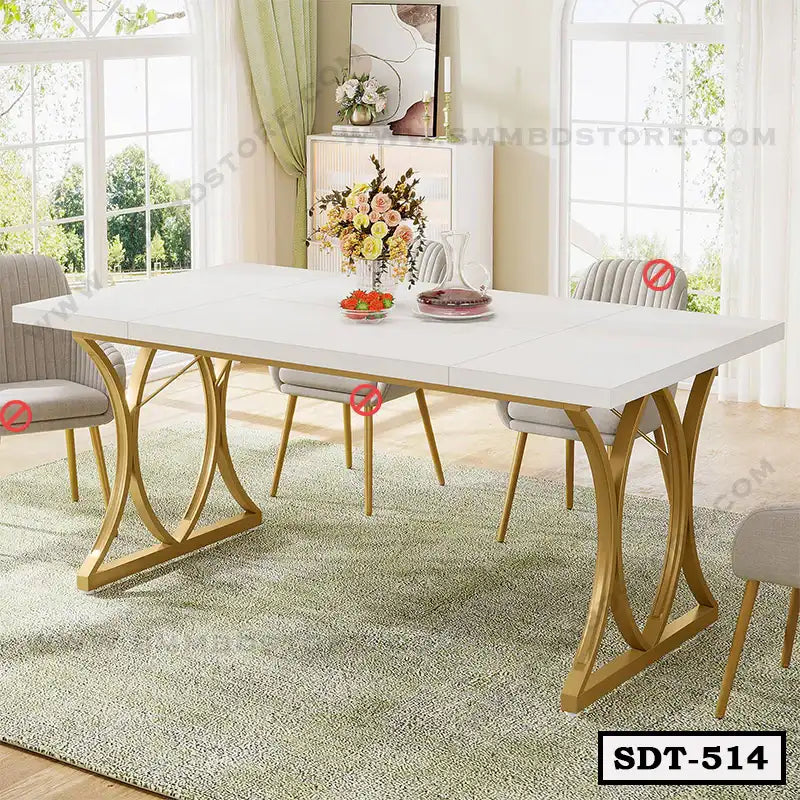 Modern steel dining table with white top and gold legs in a bright living room setting