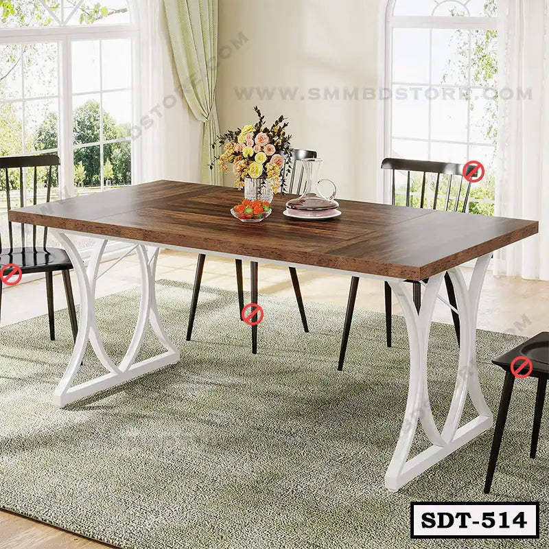 Modern steel dining table with wooden top in a bright dining room setting, chairs around, flowers and dishes on table. Main image