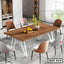 Modern steel dining table with wood finish, six upholstered chairs, and minimalist decor