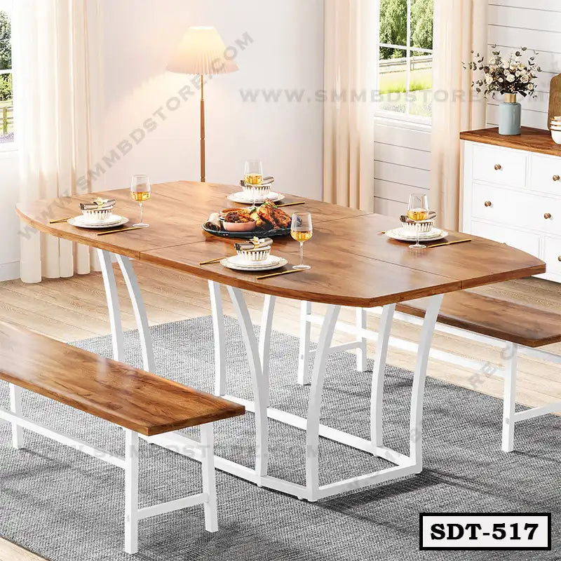 Modern wooden dining table with steel legs and benches, set for a meal in a bright dining room