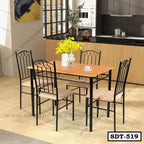Modern steel dining table set with four chairs and wood top in a bright kitchen