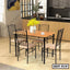 Modern steel dining table set with four chairs and wood top in a bright kitchen