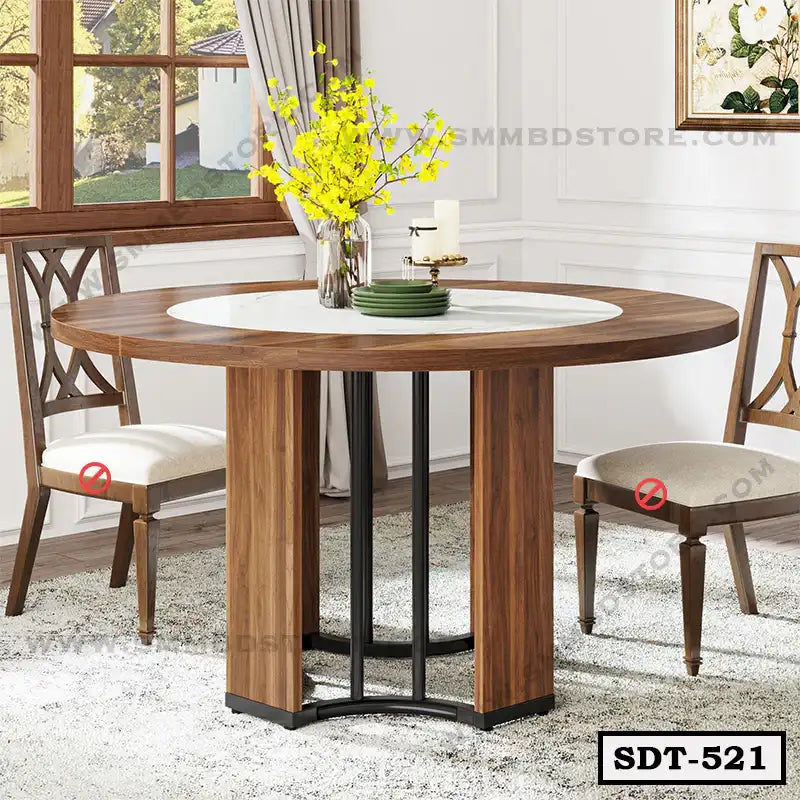 Modern round steel dining table with wood finish in a bright dining room setting