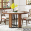 Modern round steel dining table with wood finish in a bright dining room setting