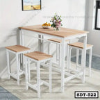 Modern steel dining table set with four stools, light wood top, white frames, indoor setting
