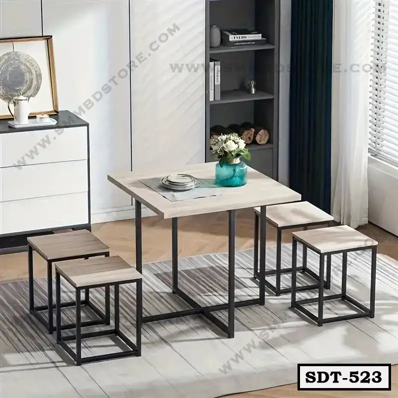 Modern steel dining table set with four square stools in a stylish room setting Main image
