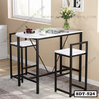 Modern steel dining table set with two chairs, black frame, white tabletop, and vase decor