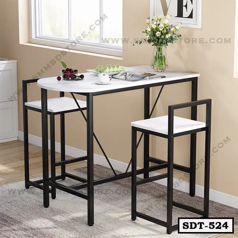 Modern steel dining table set with two chairs, black frame, white tabletop, and vase decor