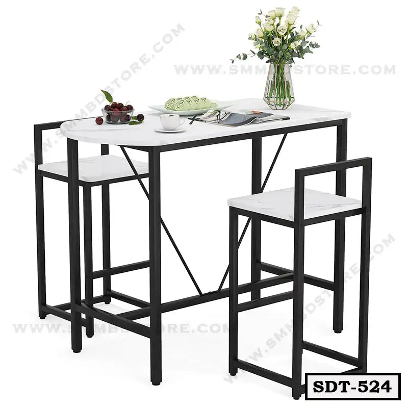 Modern steel dining table set with two chairs, black frame, white tabletop, and floral decor.