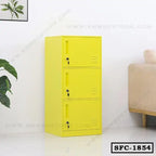 Yellow steel file cabinet with three lockable compartments in a modern office setting