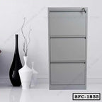 Modern grey steel file cabinet with three drawers, placed beside decorative vases in an office setting