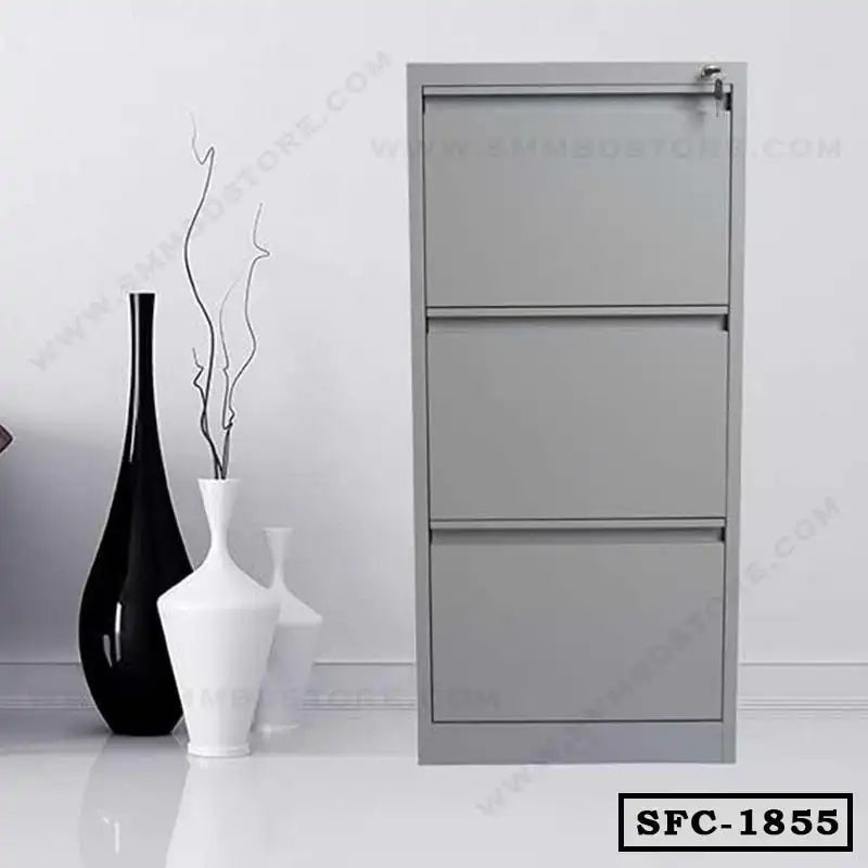 Modern grey steel file cabinet with three drawers, placed beside decorative vases in an office setting