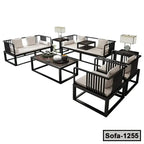 Modern steel sofa set with cream cushions, matching coffee table, and side tables with lamps
