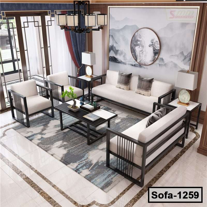 Modern steel frame living room sofa set with light cushions, coffee table, and decorative rug
