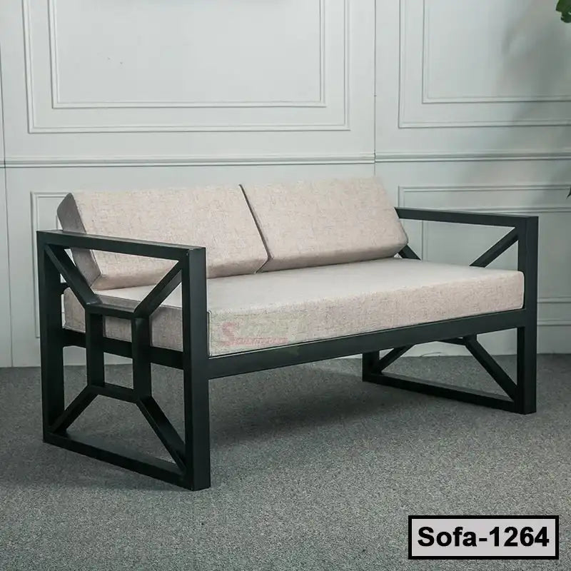 Modern steel frame sofa with light beige cushions, geometric armrests, indoor setting
