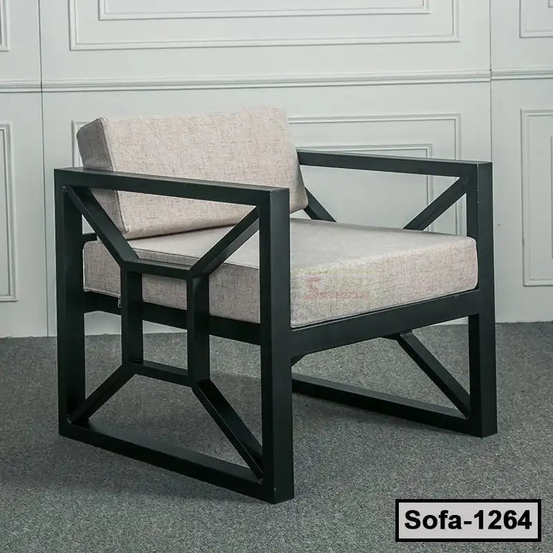 Modern single-seater steel frame sofa with beige cushions in a minimal living room