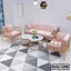 Modern living room with pink velvet steel frame sofa set and marble coffee tables