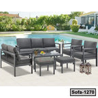 Modern grey steel outdoor sofa set with cushions and table by a swimming pool