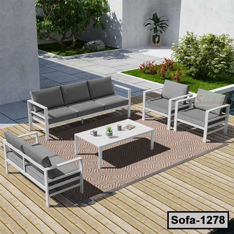 Modern outdoor steel sofa set with gray cushions on wooden deck, garden background