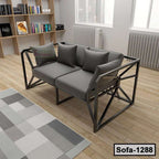 Modern steel frame sofa with gray cushions and pillows in a bright living room
