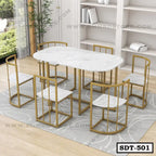 Modern marble top steel dining table set with six chairs on a grey rug in a bright room