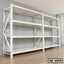 Large white metal storage rack with four shelves, placed against a wall on wooden flooring