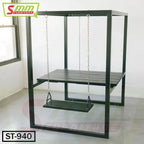 Modern swing table with black metal frame, wooden tabletop, and hanging seat indoors