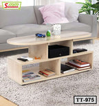 Modern wood tea table with open shelving, books, mug, and remotes in a living room