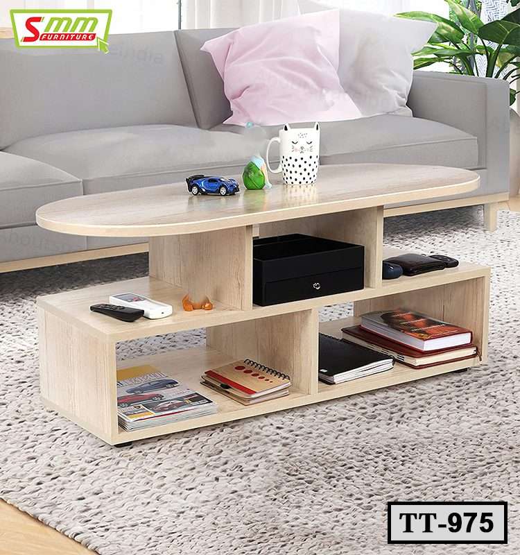 Modern wood tea table with open shelving, books, mug, and remotes in a living room